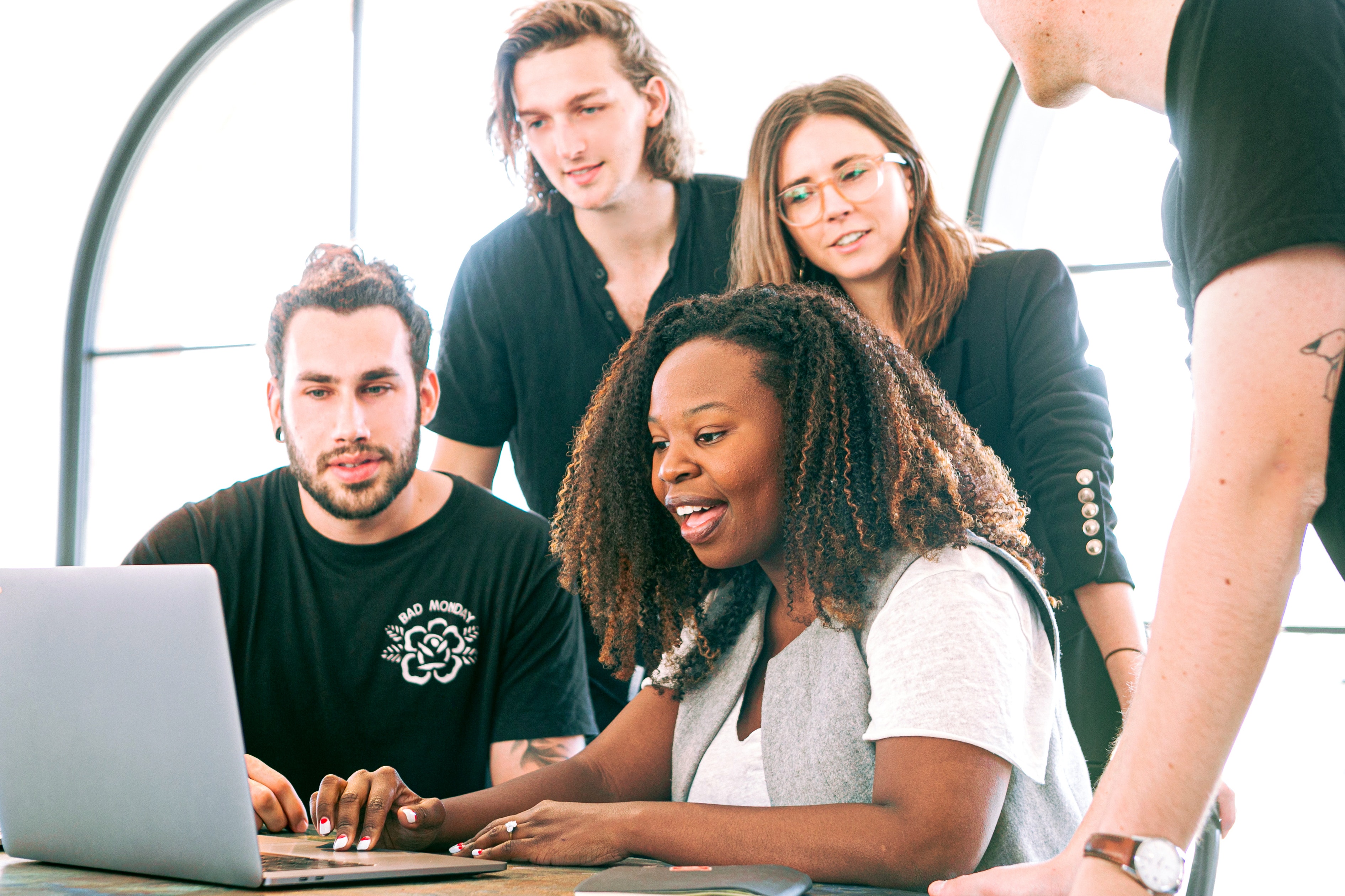 Group of people looking at a laptop screen
